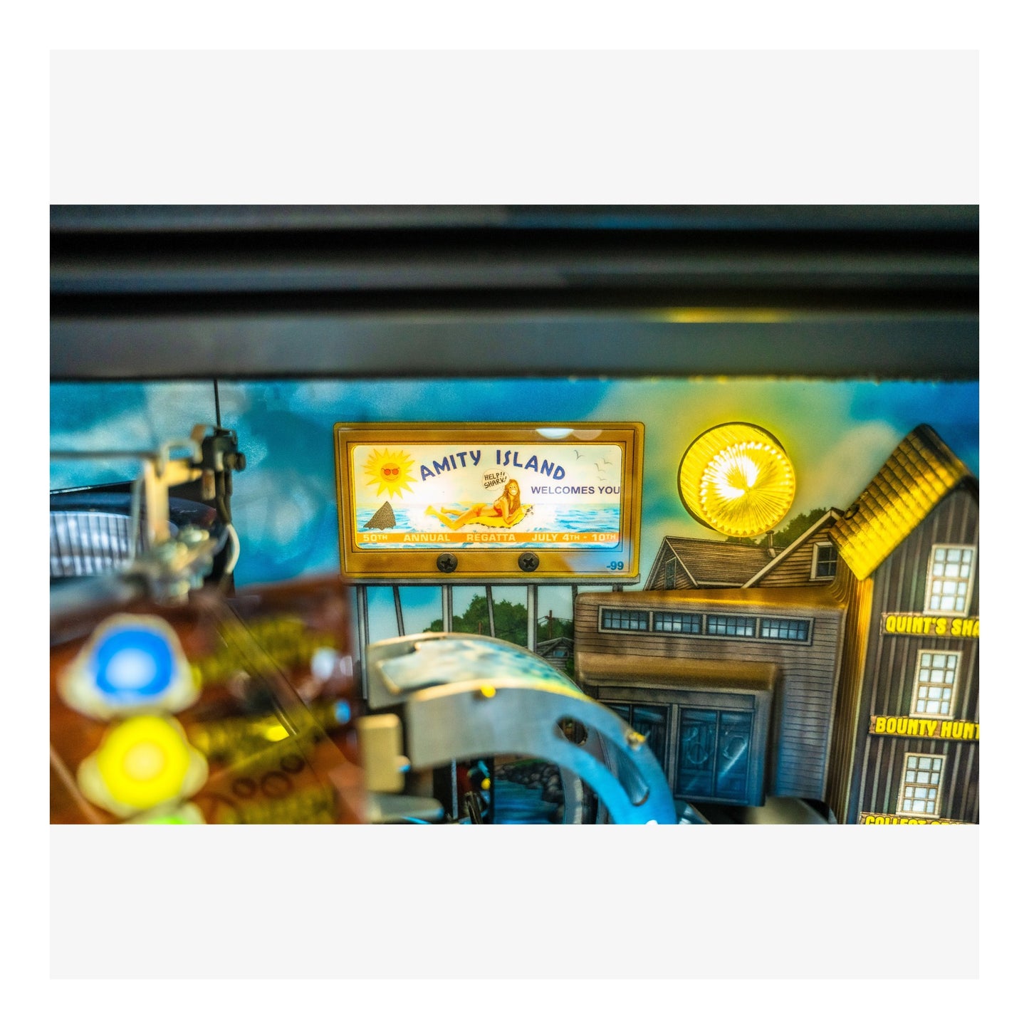 Amity Island sign in a themed setting with a boat and other decorations.