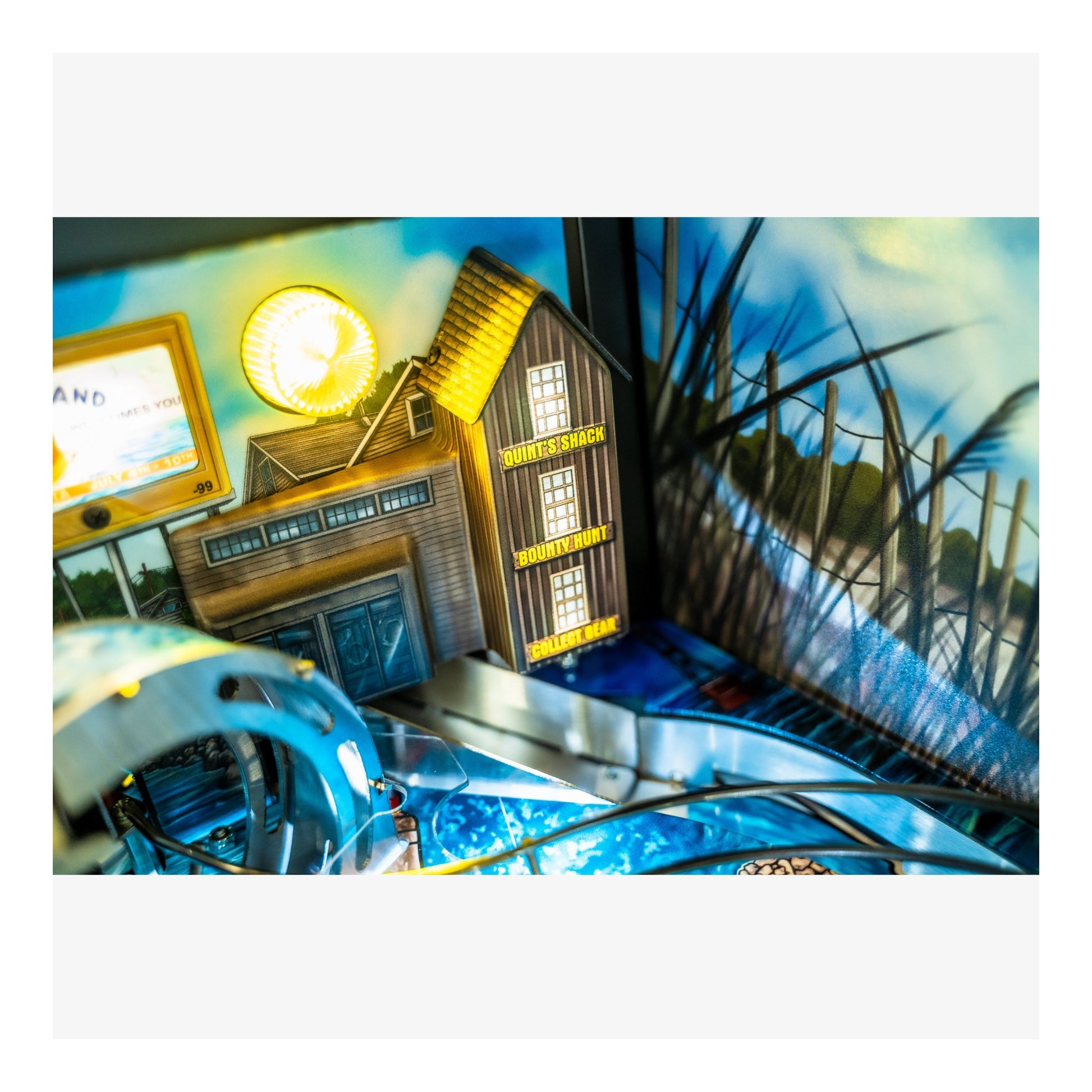 Toy train set with a detailed station and scenic background