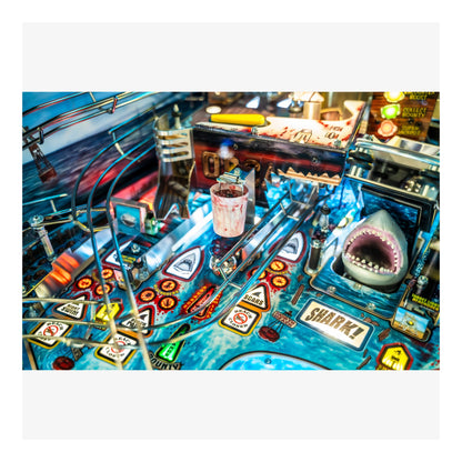 Close-up of a pinball machine with shark-themed design