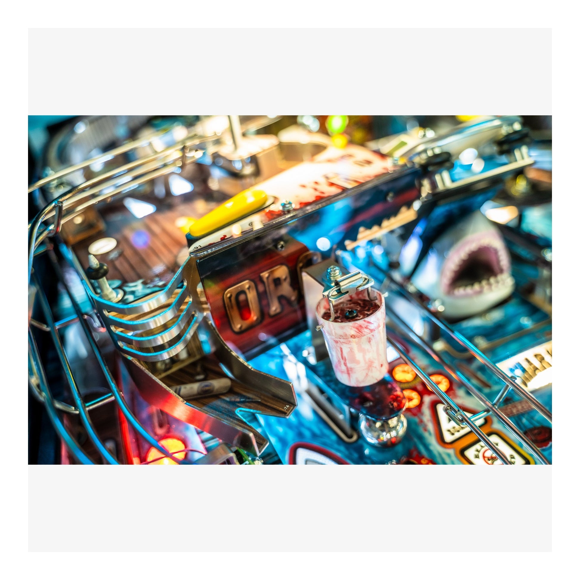 Close-up of a pinball machine with colorful lights and details