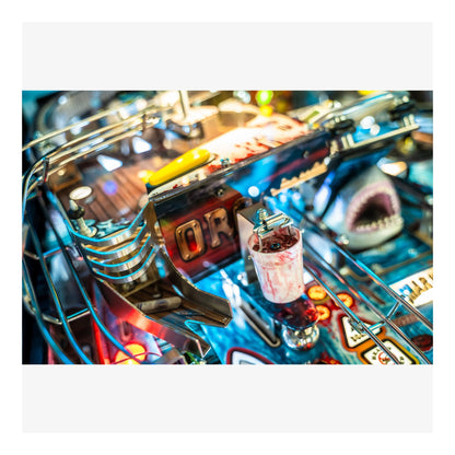 Close-up of a pinball machine with colorful lights and details