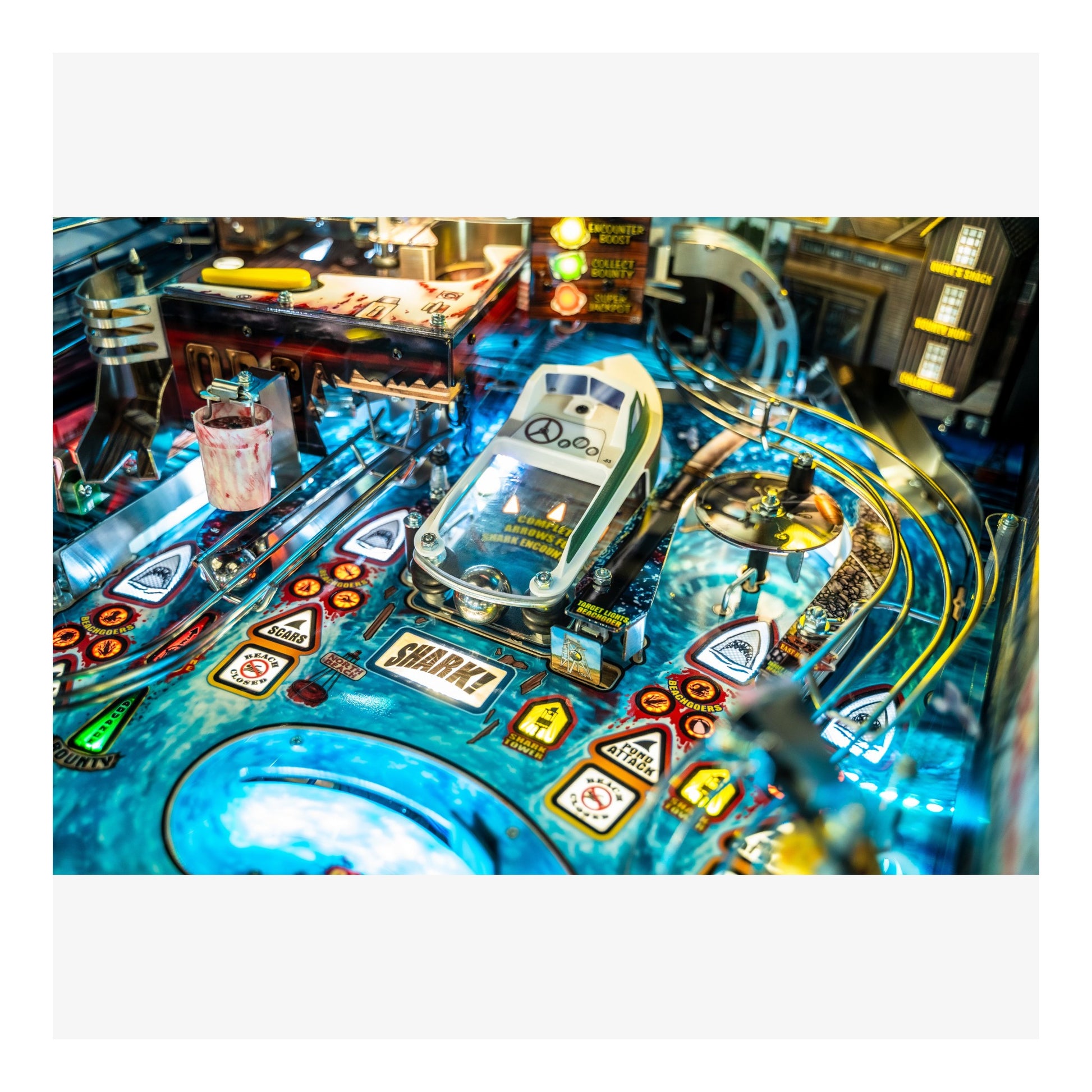 Close-up of a pinball machine with various symbols and lights.