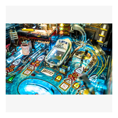 Close-up of a pinball machine with various symbols and lights.