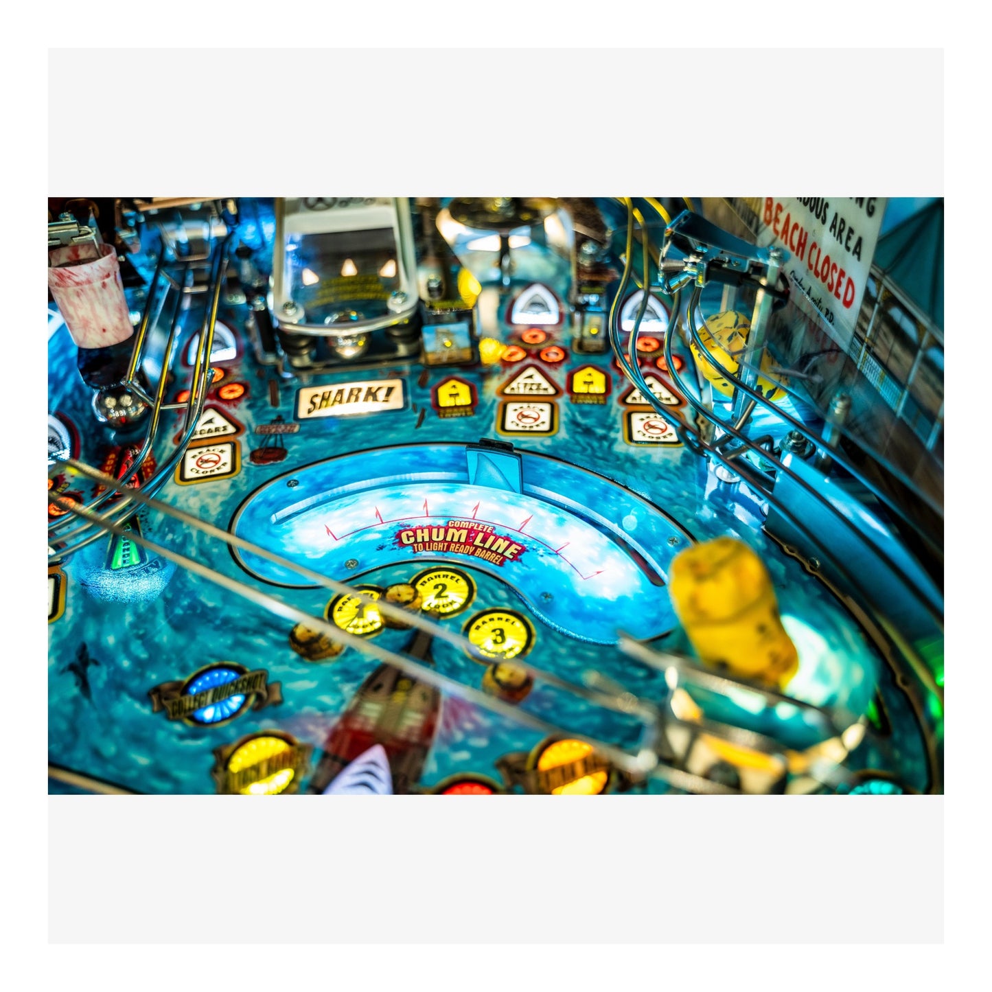 Close-up of a pinball machine with various lights and symbols.