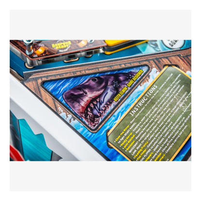 Close-up of a shark-themed arcade machine with instructions and a screen displaying a shark image.