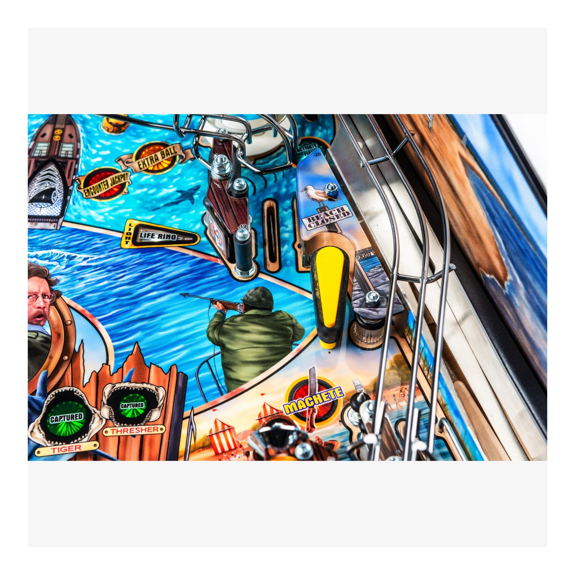 Close-up of a colorful pinball machine with various symbols and graphics.