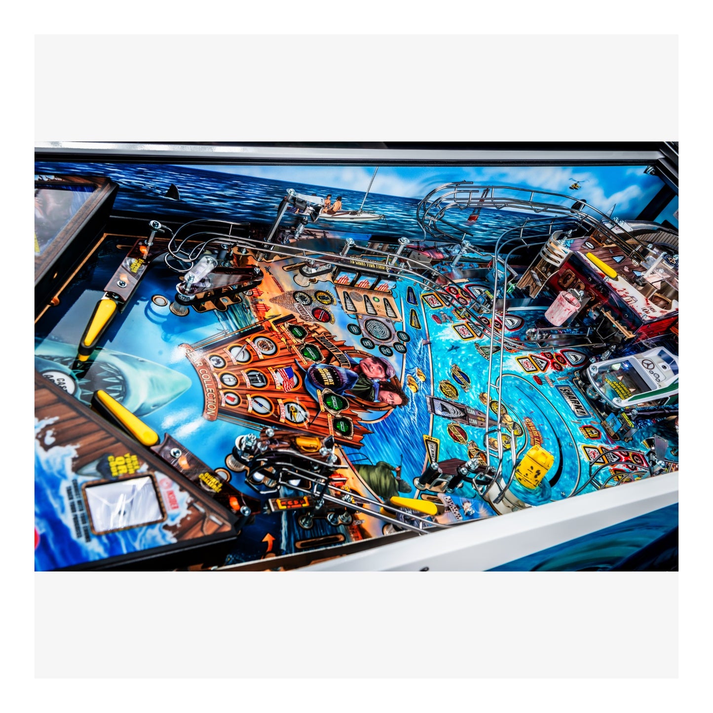 Close-up of a pinball machine with colorful design and various components.