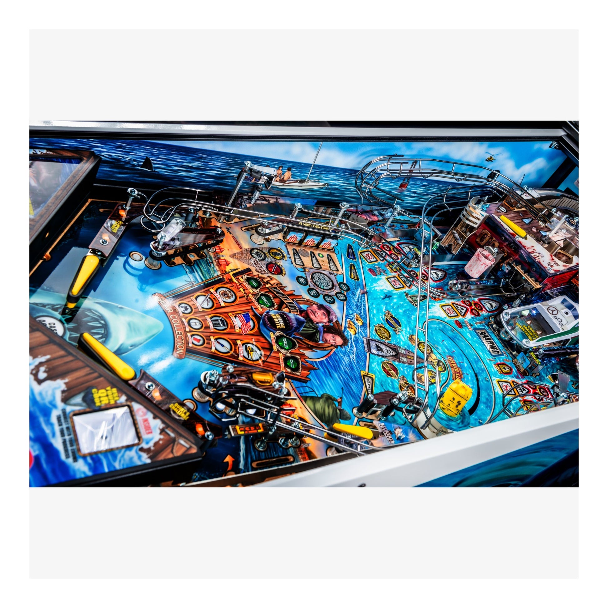 Close-up of a pinball machine with colorful design and various components.