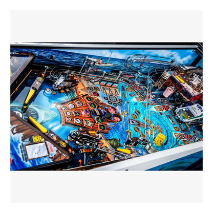Close-up of a pinball machine with colorful design and various components.