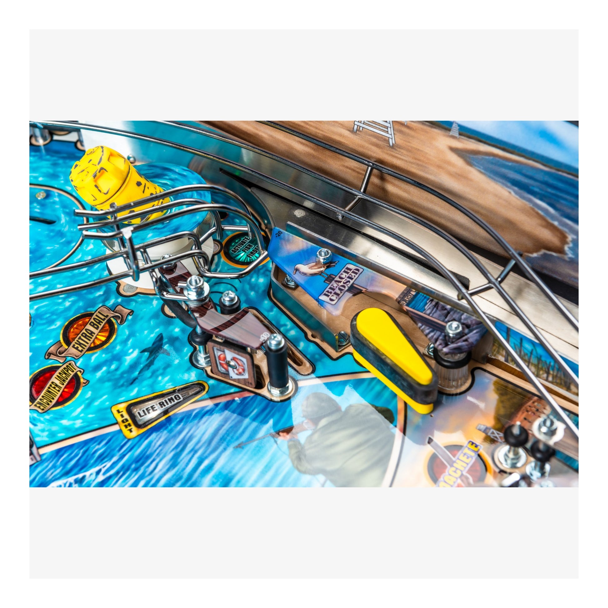 Close-up of a pinball machine with detailed playfield and components.