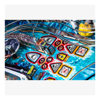 Close-up of a colorful pinball machine with various symbols and designs.