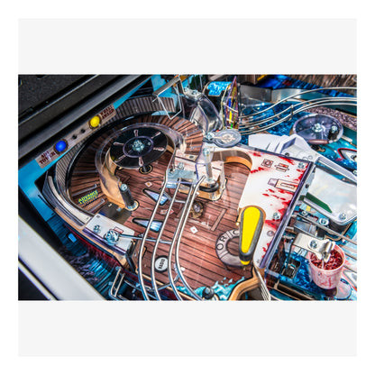 Close-up of a pinball machine with wooden track and colorful details