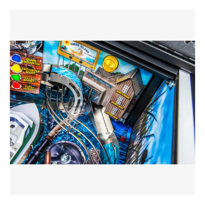 Close-up of a pinball machine with detailed artwork and colorful elements.