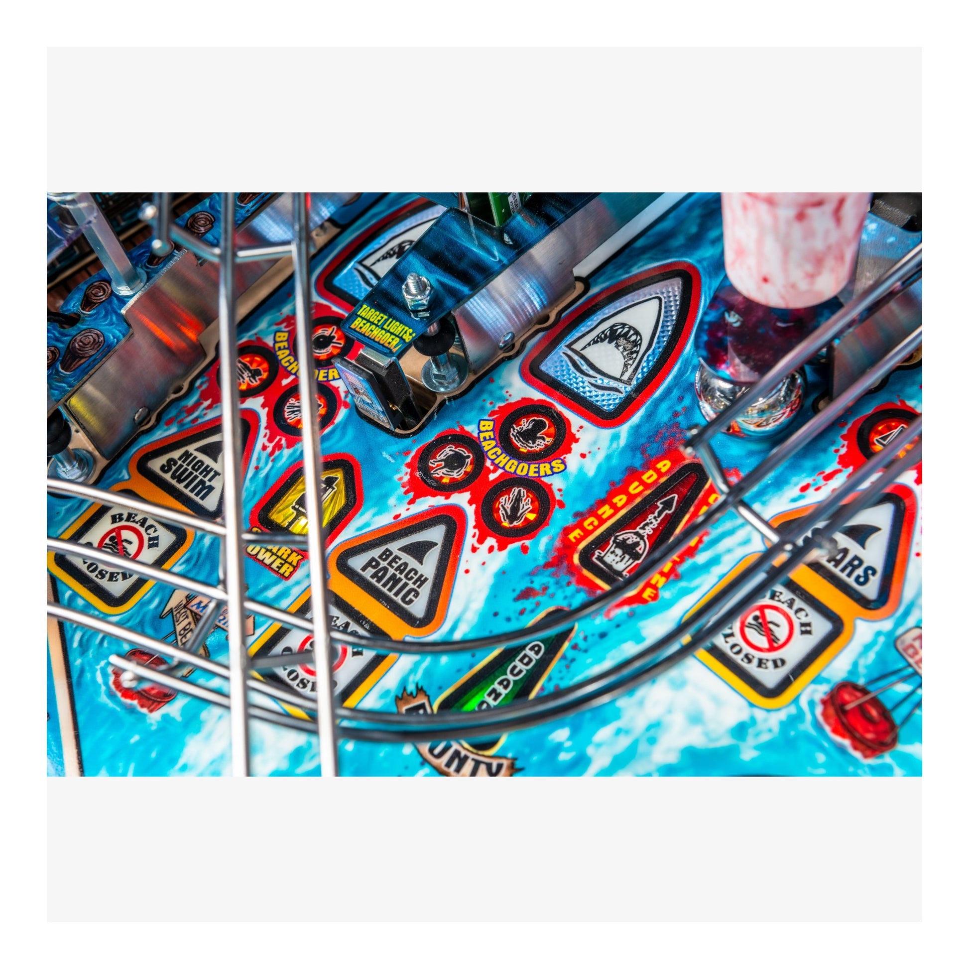 Close-up of a colorful pinball machine with various symbols and designs.