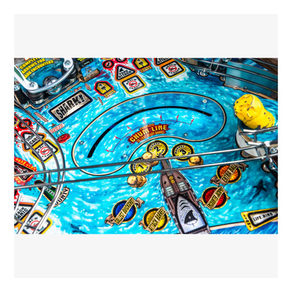 Close-up of a pinball machine with colorful design and various symbols.