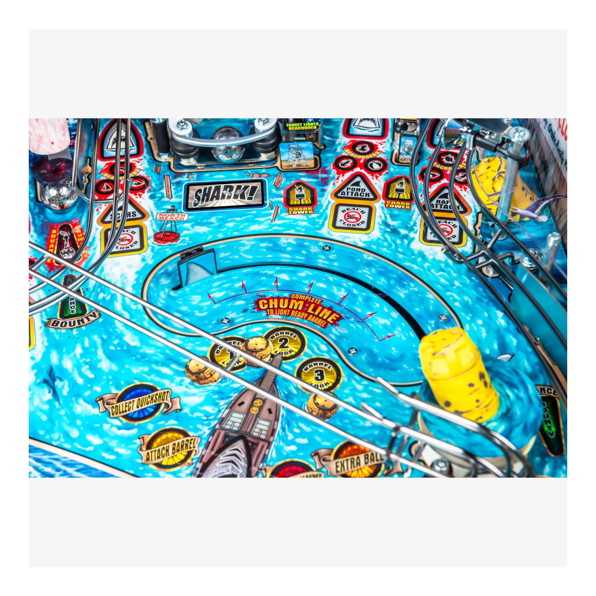 Close-up of a pinball machine with colorful design and various elements.