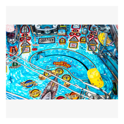 Close-up of a pinball machine with colorful design and various elements.