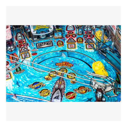 Close-up of a pinball machine with various symbols and text on a blue background