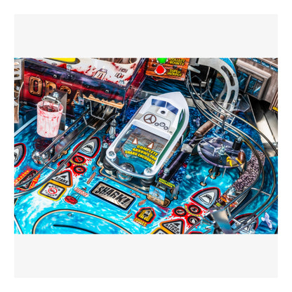 Close-up of a pinball machine with colorful design and various elements.