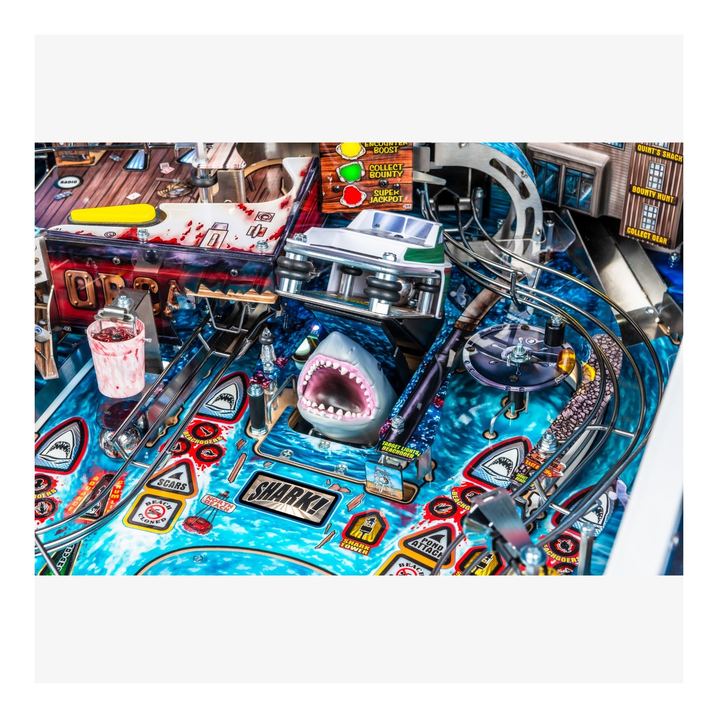 Pinball machine with shark figure and colorful design