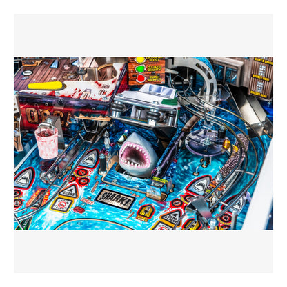 Pinball machine with shark figure and colorful design