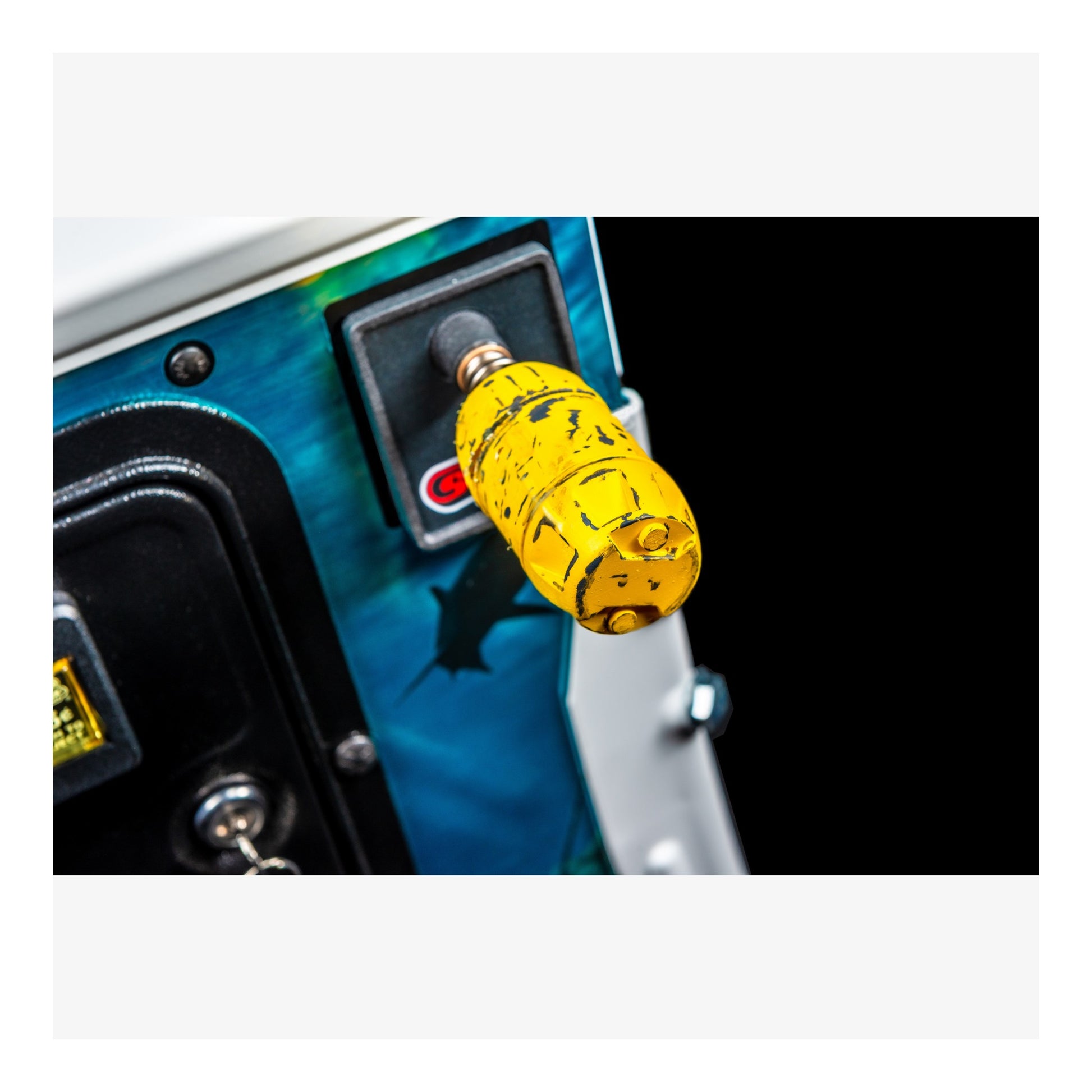 Close-up of a yellow toggle switch on a vehicle panel with a black background
