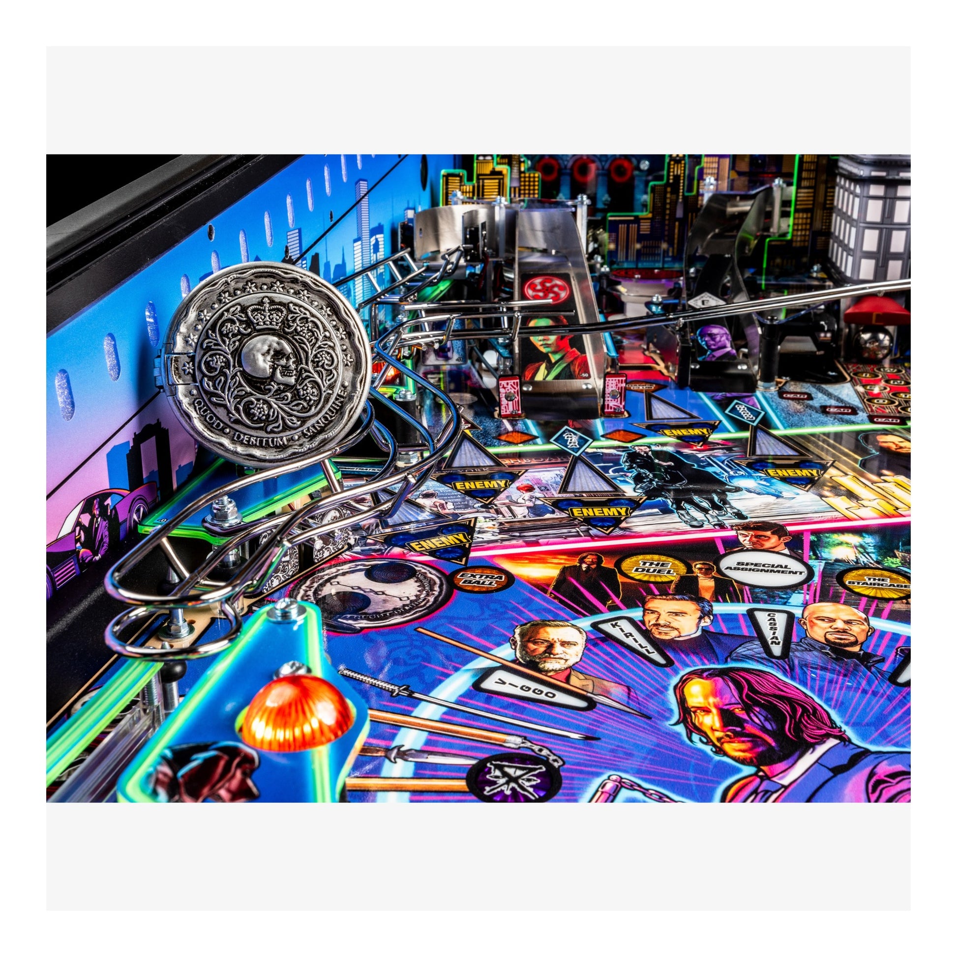 Close-up of a pinball machine with colorful artwork and player portraits.