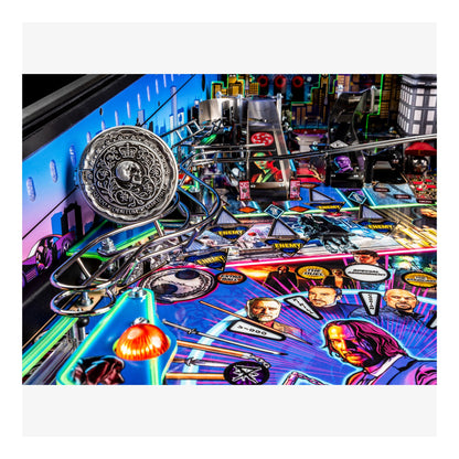 Close-up of a pinball machine with colorful artwork and player portraits.