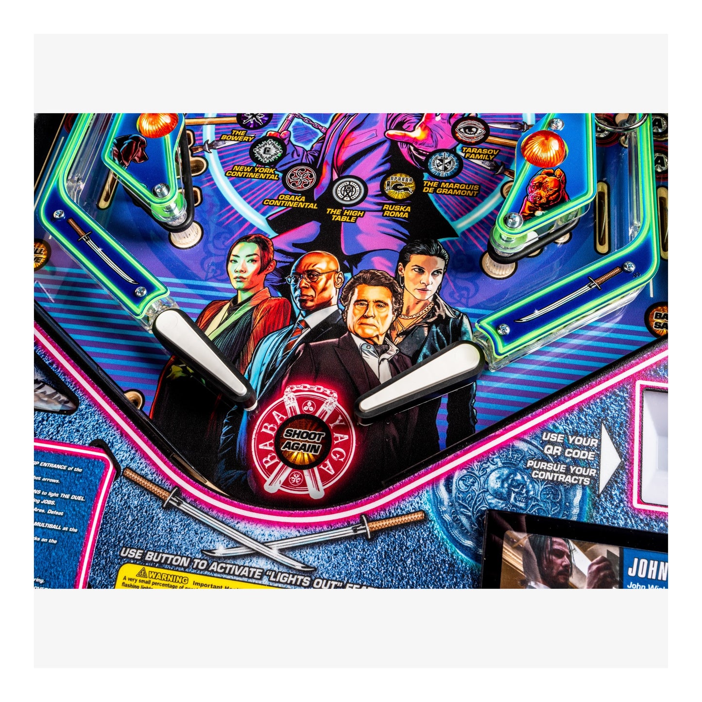 Close-up of a pinball machine with colorful design and characters on a white background