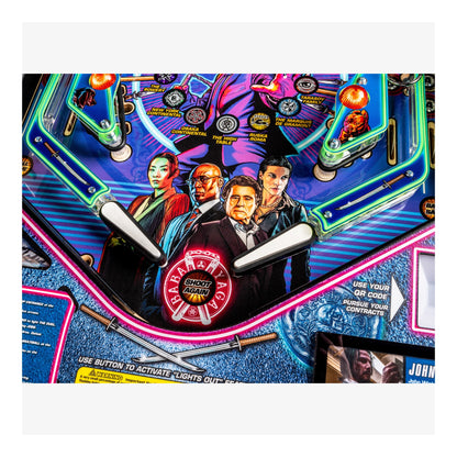 Close-up of a pinball machine with colorful design and characters on a white background