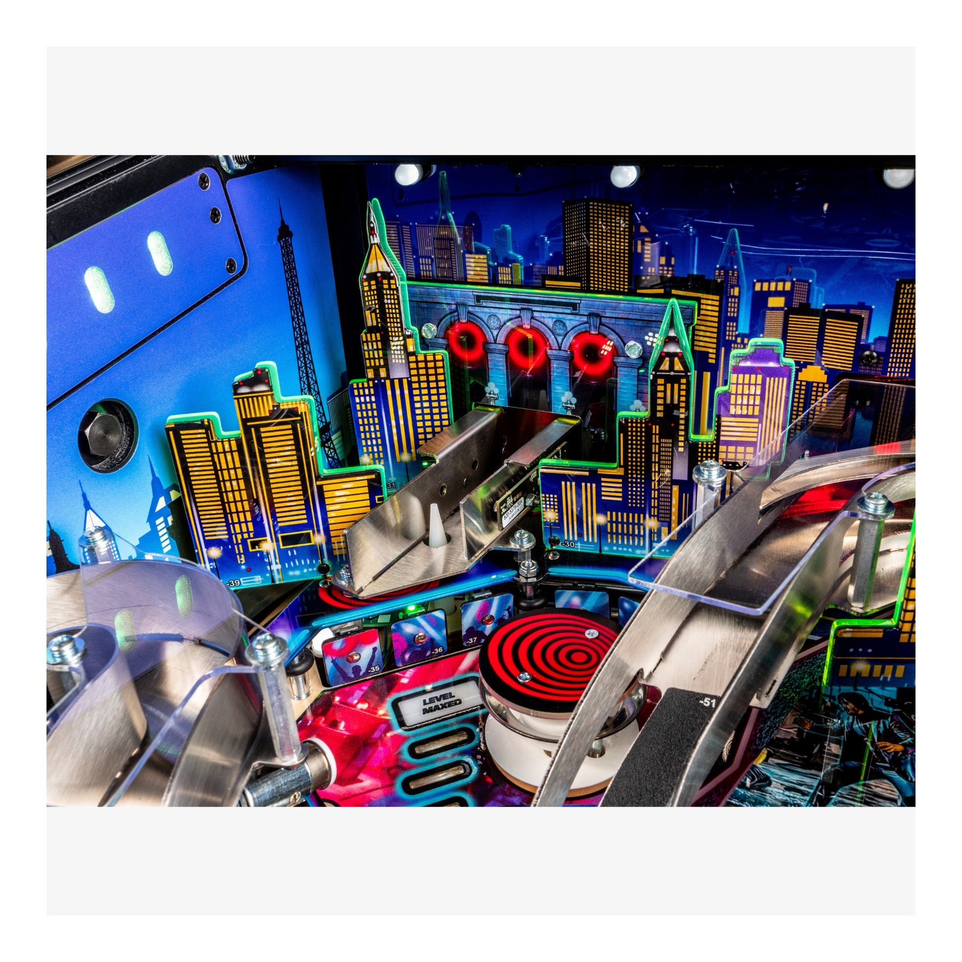 Close-up of a pinball machine with vibrant cityscape background