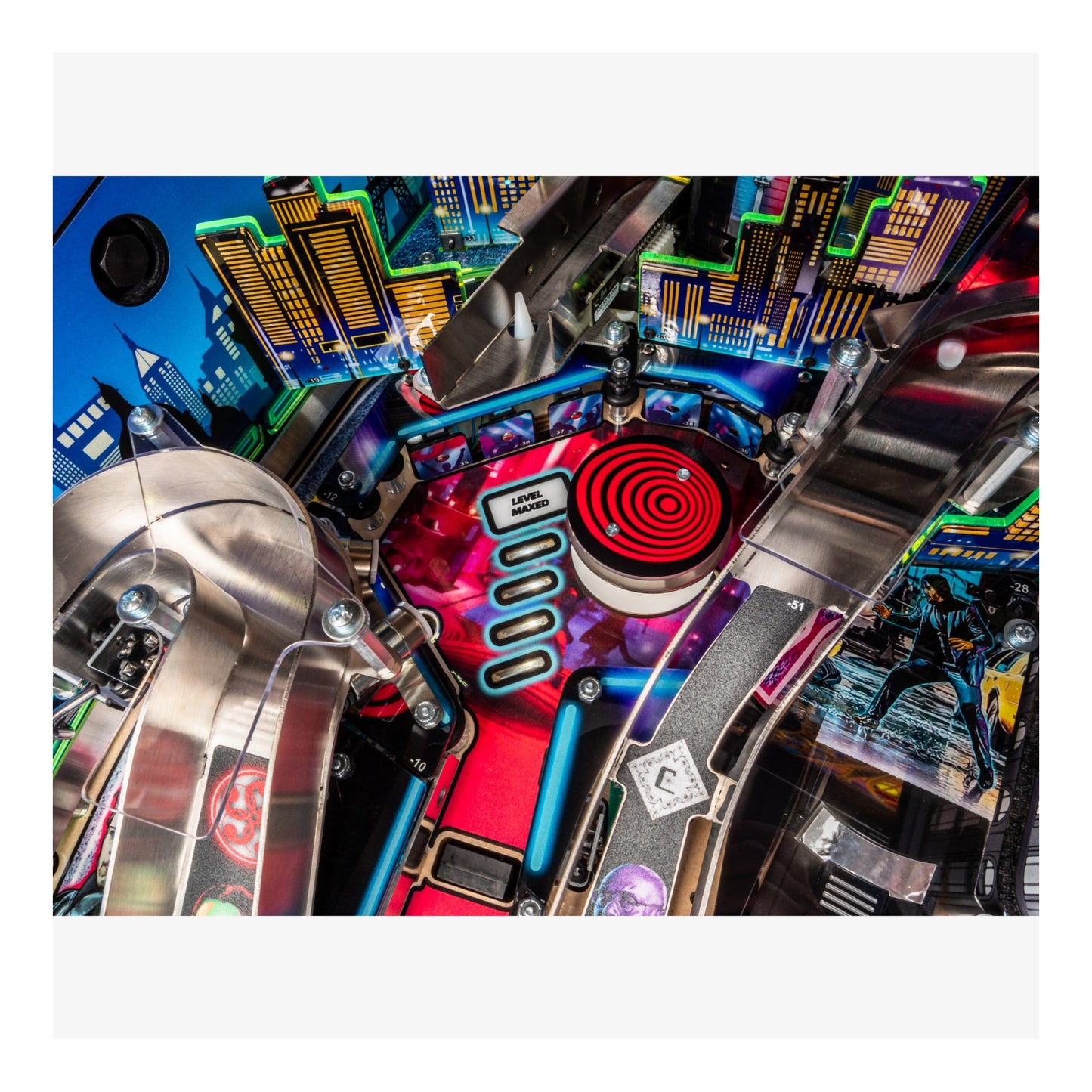 Close-up of a colorful pinball machine with vibrant lights and mechanical components.