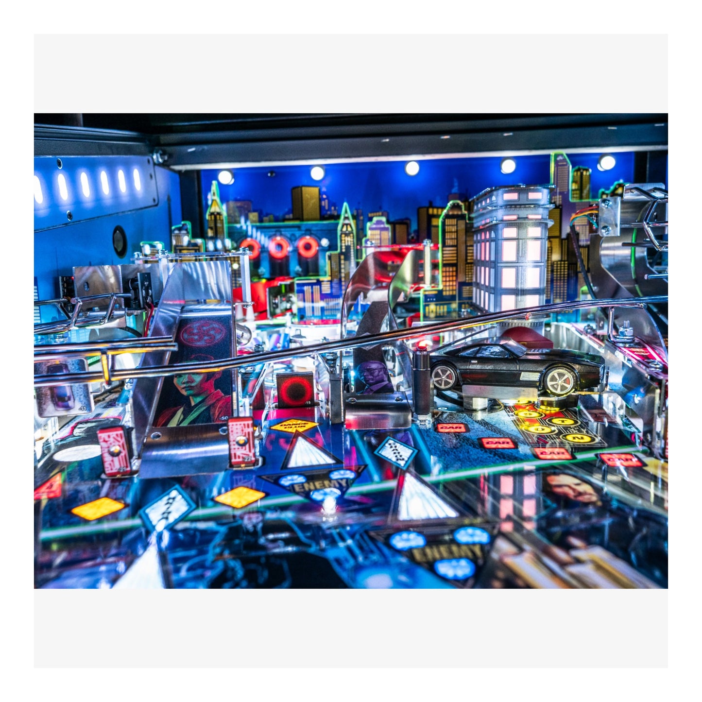 Pinball machine with colorful lights and a cityscape background