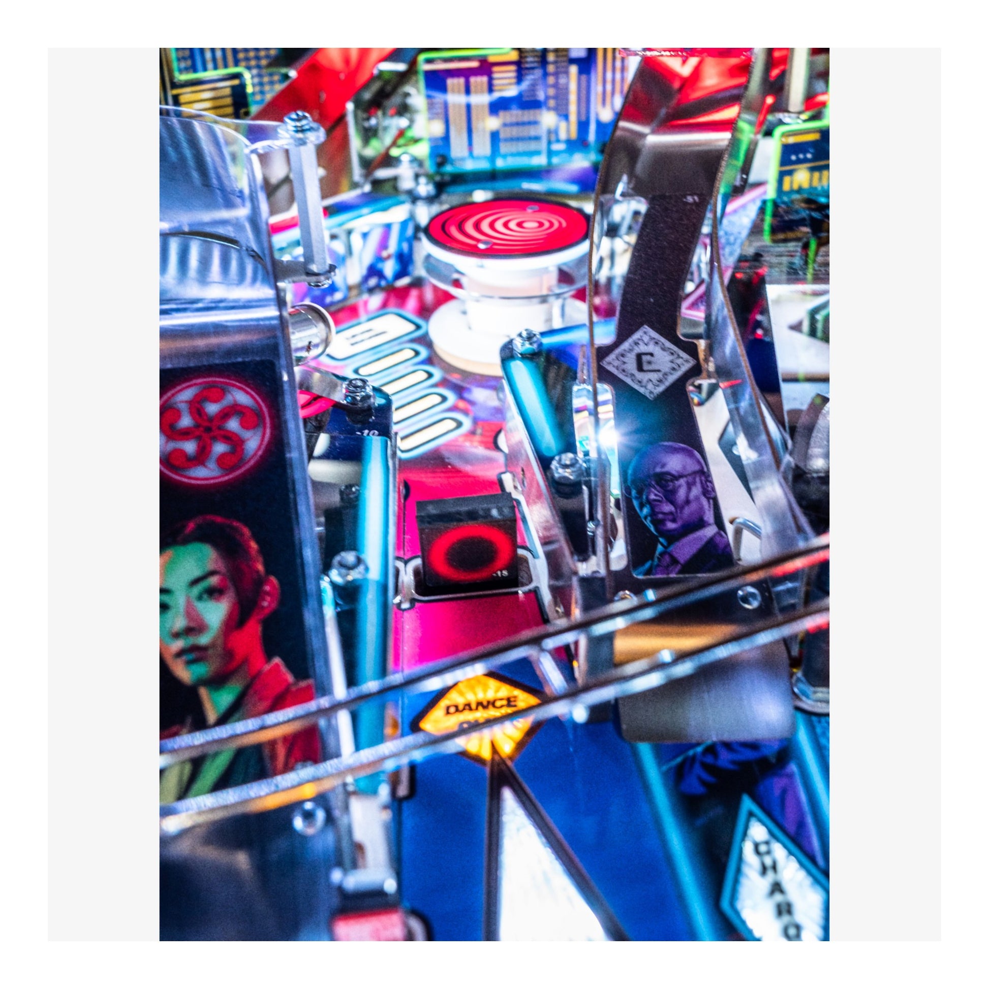 Close-up of a colorful pinball machine with various elements and characters.