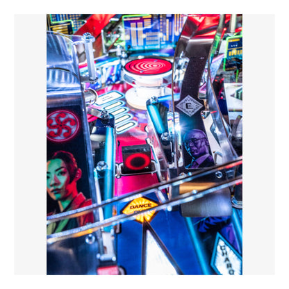 Close-up of a colorful pinball machine with various elements and characters.