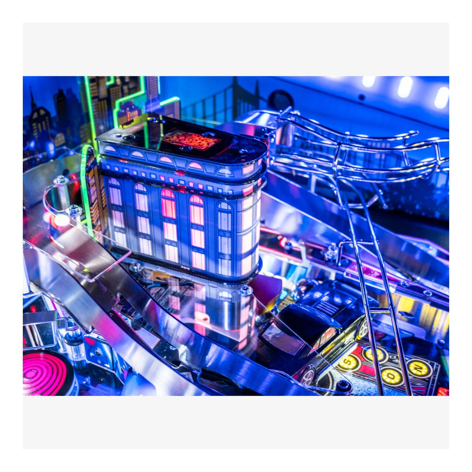 Neon-lit pinball machine with colorful lights and reflections.