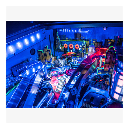 Close-up of a pinball machine with vibrant blue and red lighting