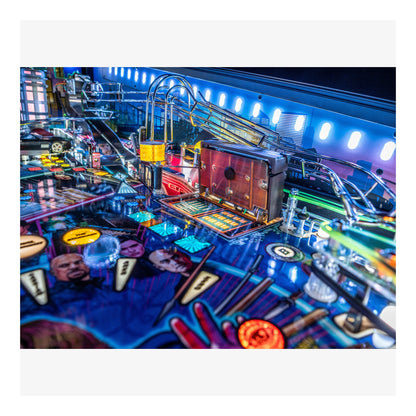 Close-up of a colorful pinball machine with various components and lights.