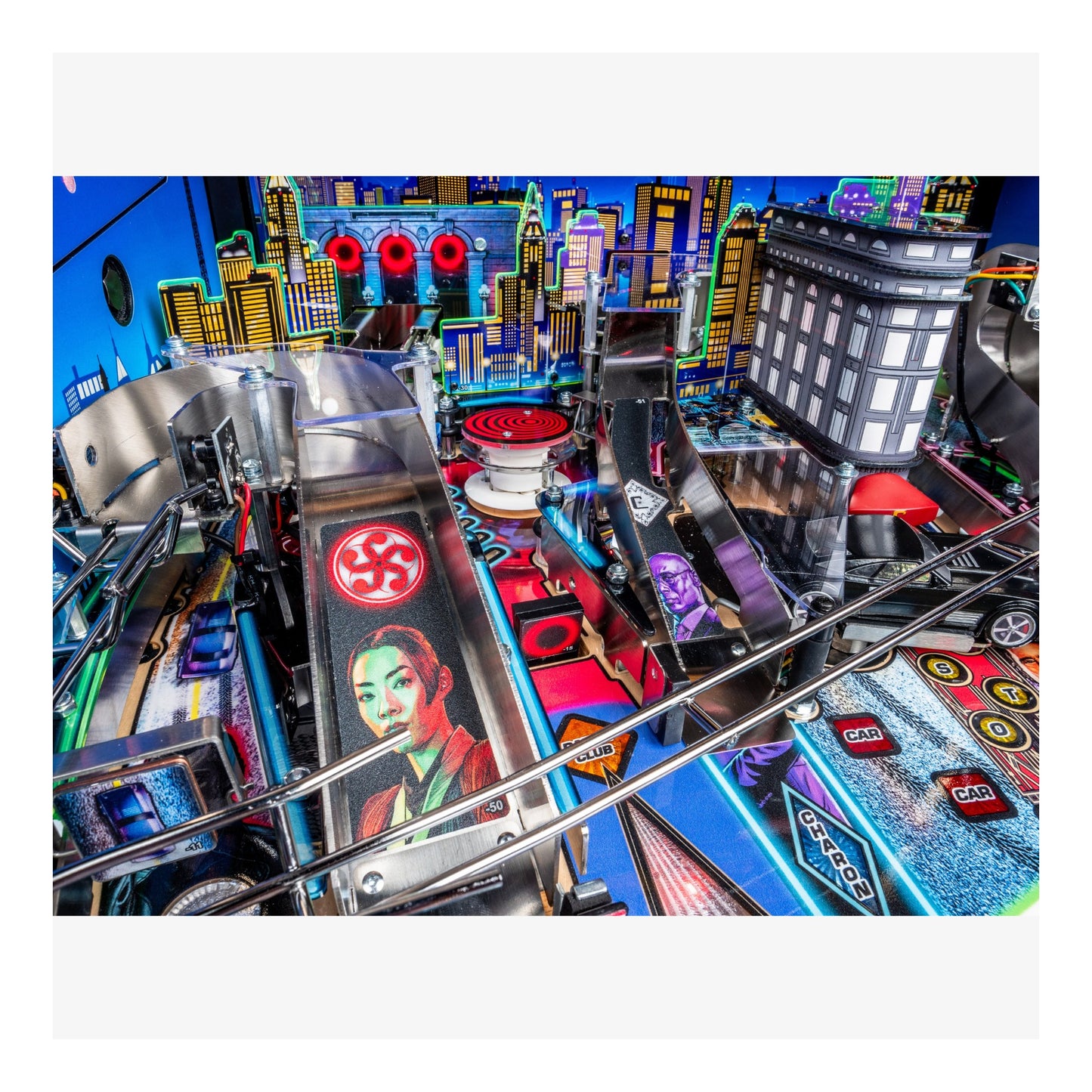 Close-up of a pinball machine with colorful playfield and vibrant cityscape background