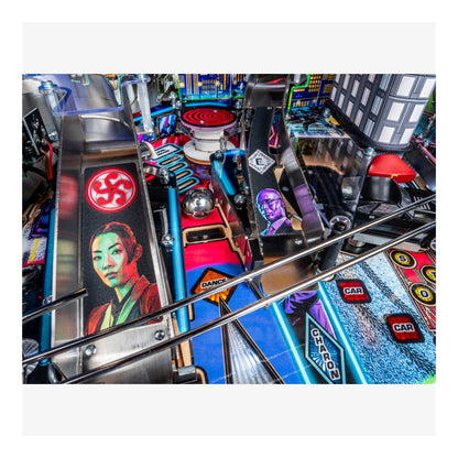Close-up of a pinball machine with colorful marbles and player portraits.