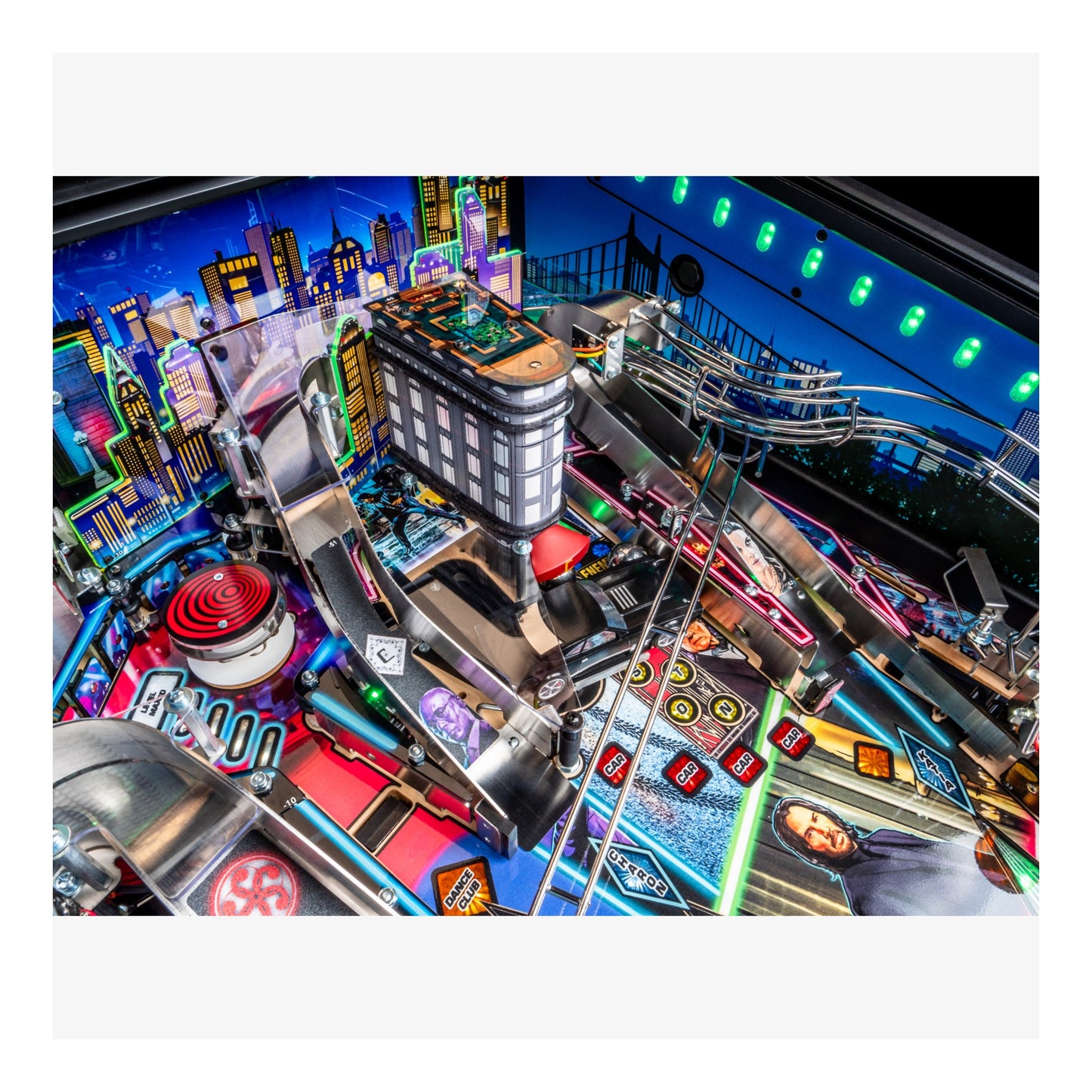 Close-up of a pinball machine with colorful lights and details.