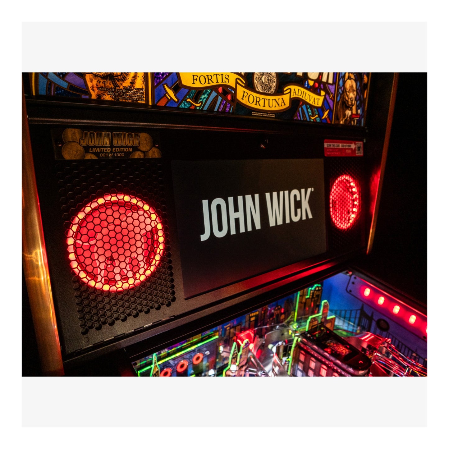 Pinball machine with 'John Wick' branding and colorful lights.