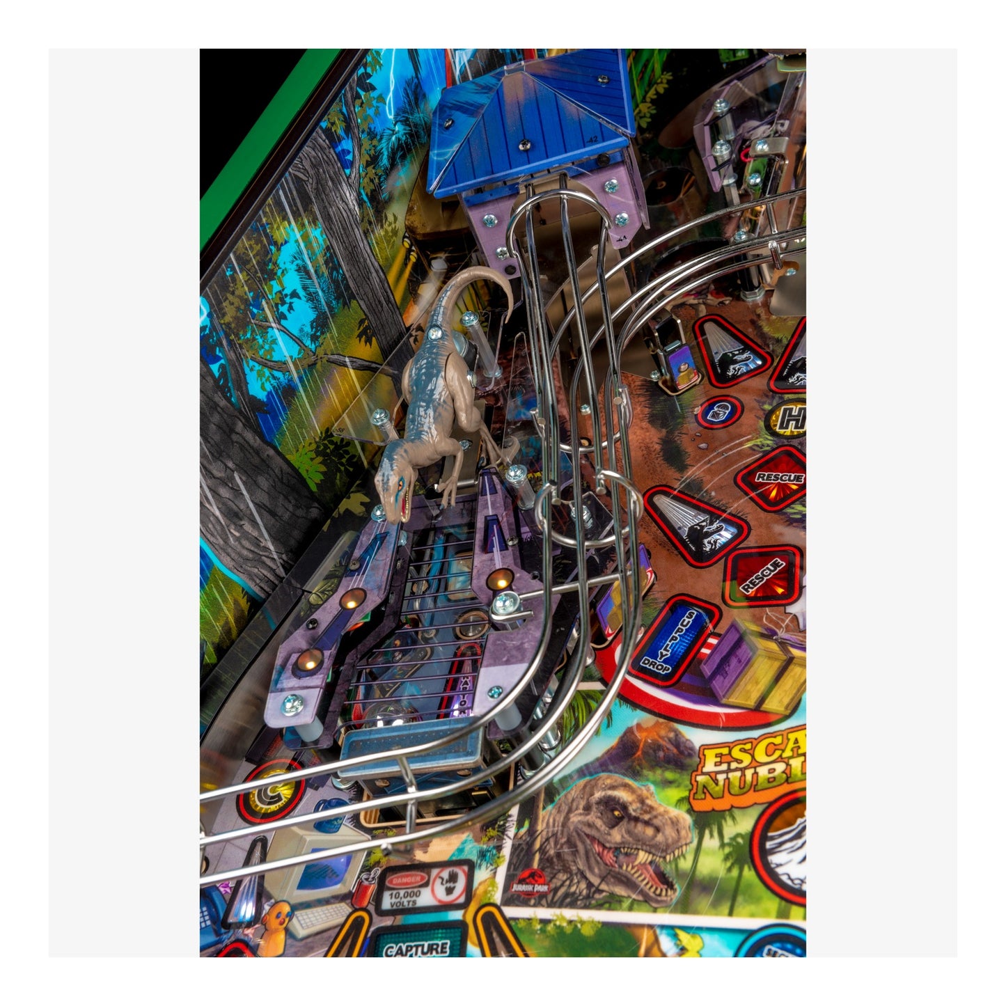 Close-up of a pinball machine with a dinosaur theme