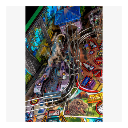 Close-up of a pinball machine with a dinosaur theme