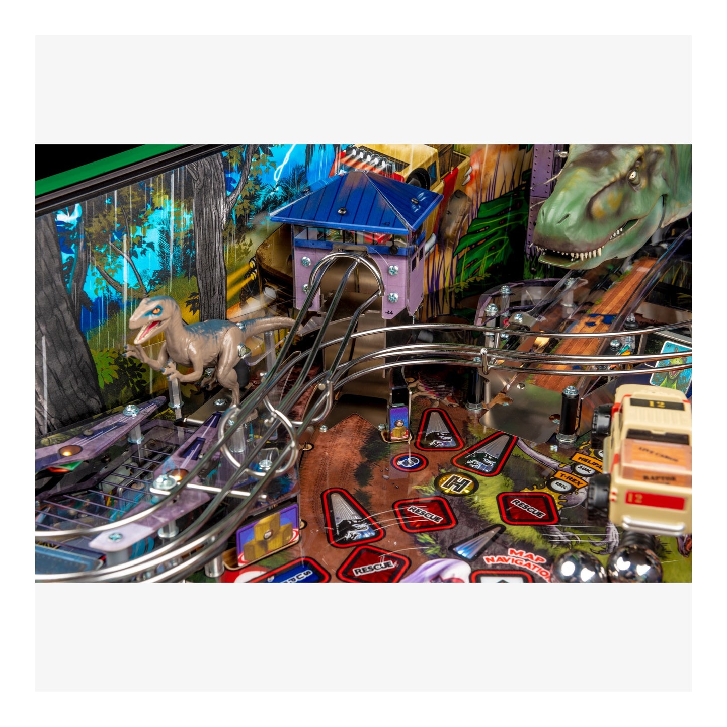 Close-up of a pinball machine with dinosaur-themed design