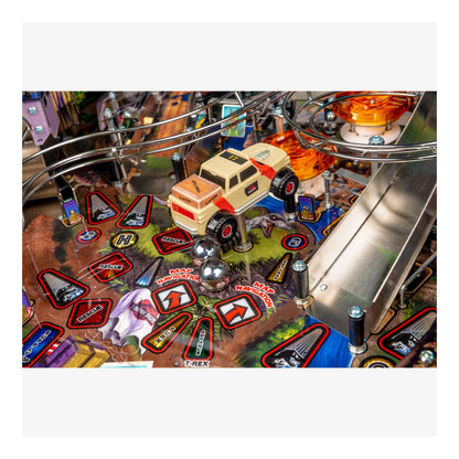 Close-up of a pinball machine with a vehicle figure and various game elements.