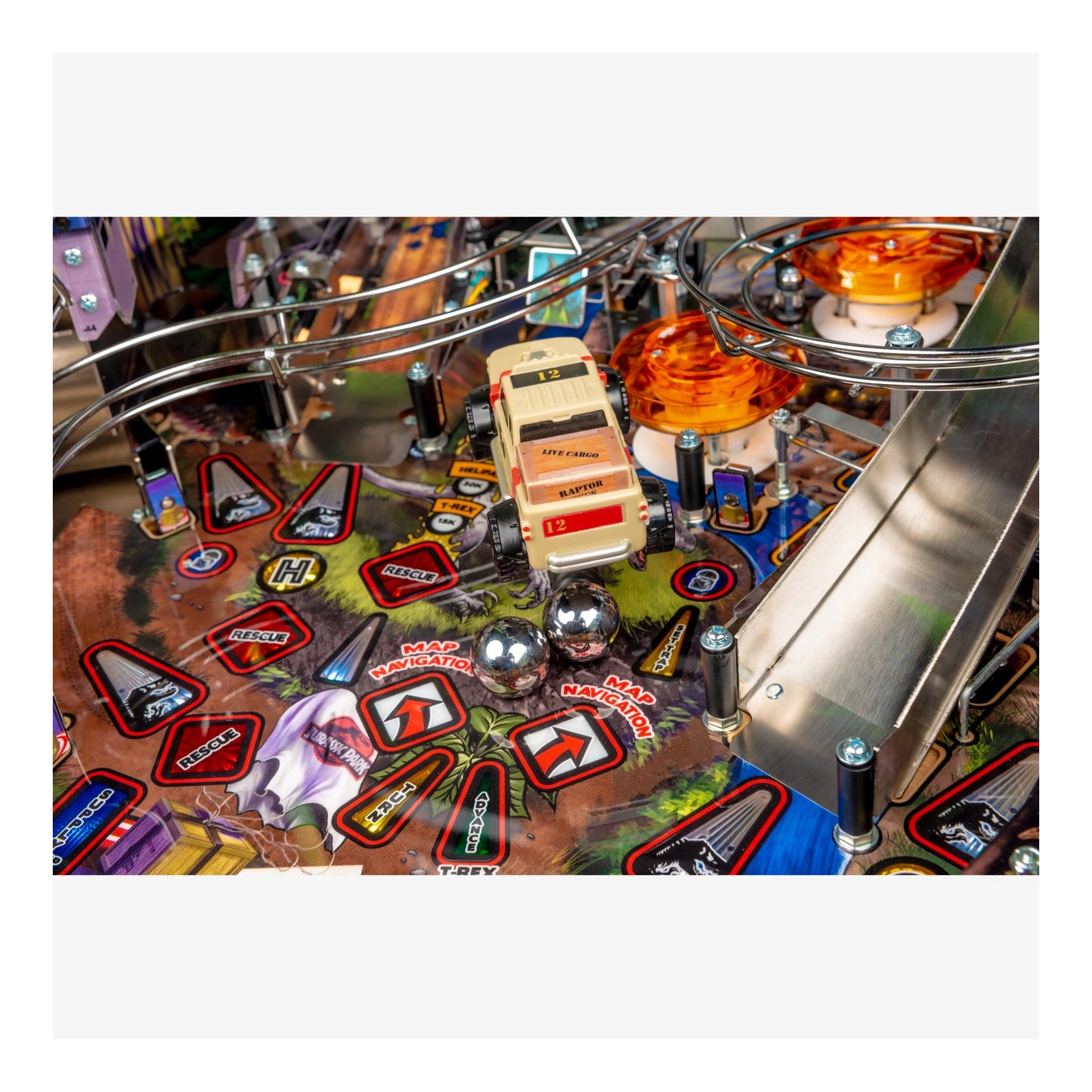 Close-up of a pinball machine with various components and symbols on the playing field.