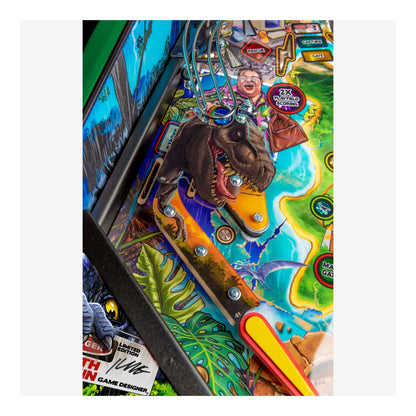 Close-up of a colorful pinball machine with detailed artwork and player figure.