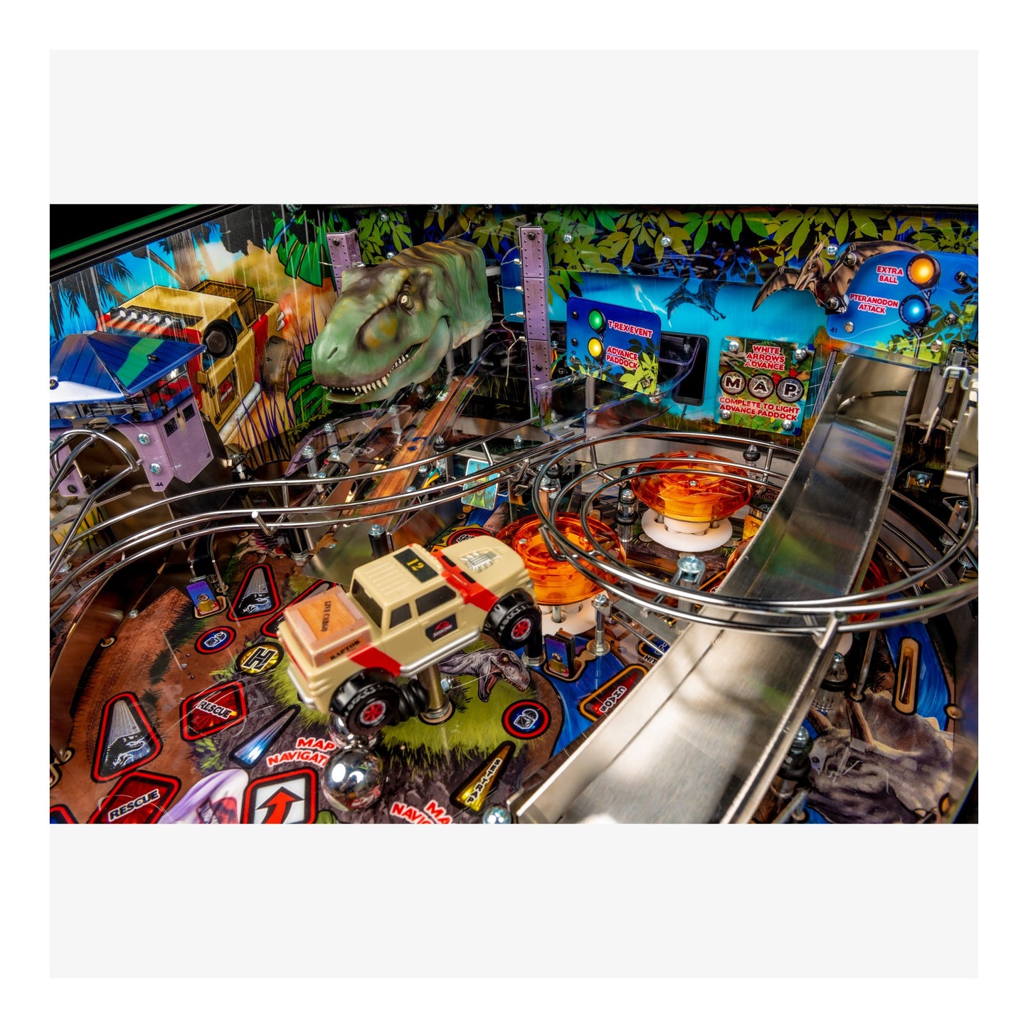 Close-up of a pinball machine with various toys and graphics on a colorful background