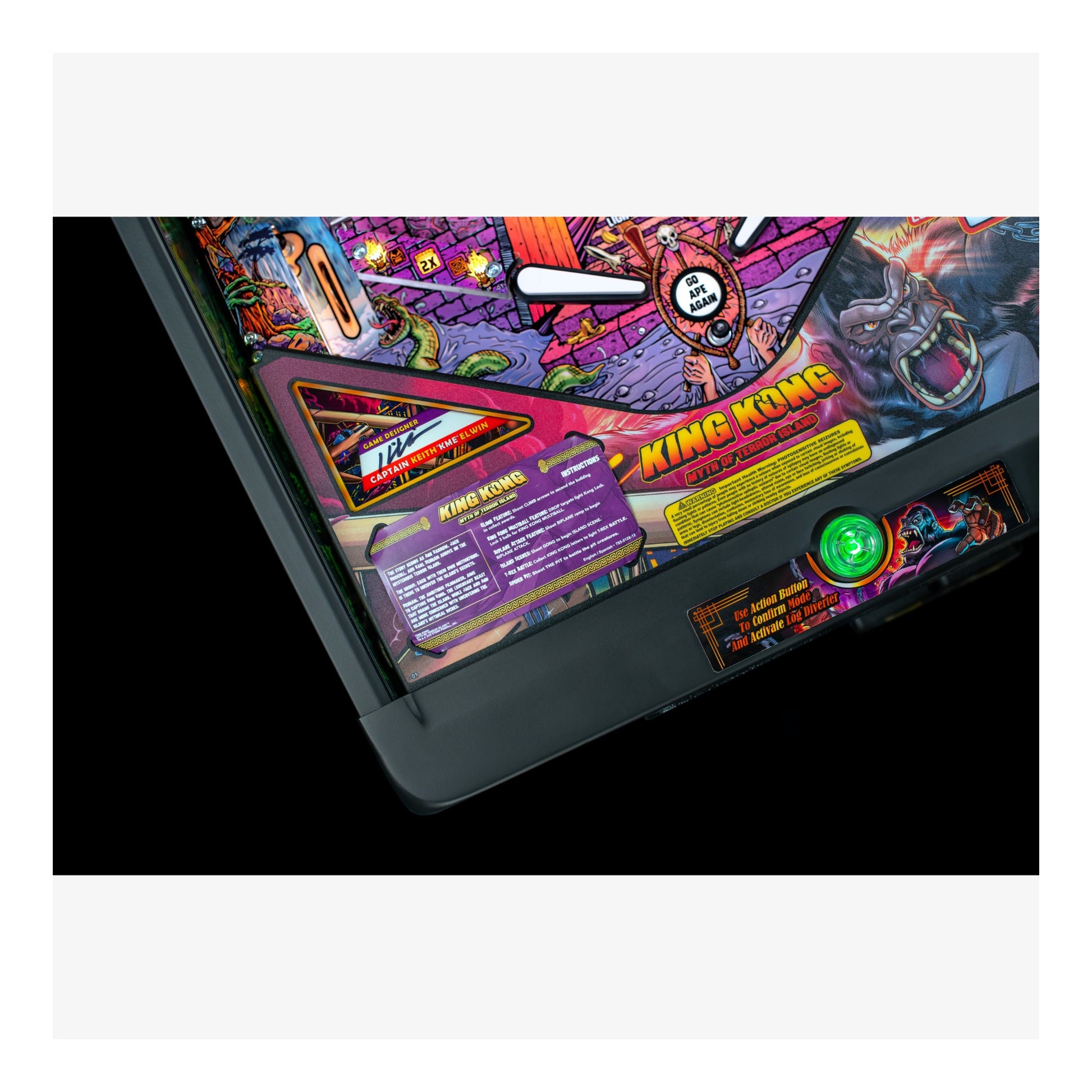 Close-up of a colorful pinball machine with 'King Kong' branding on a white background